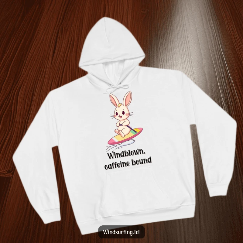 Funny bouncing bunny sailboarding with windblown ears featured on a cozy hoodie, symbolizing freedom and playful energy.