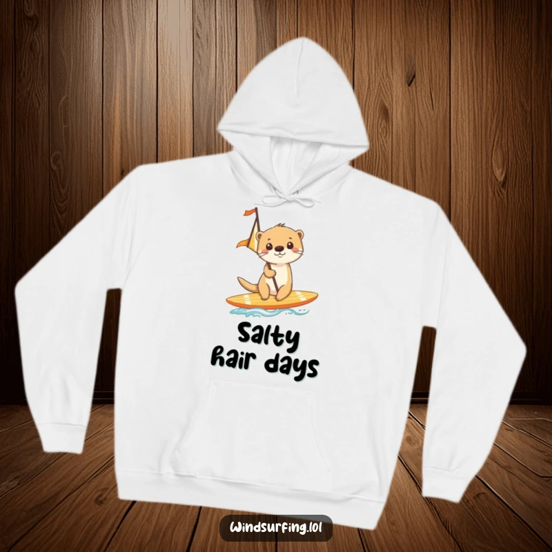 Funny hoodie illustrating a cheerful otter gliding on a surfboard with a sail, embracing the ocean breeze.
