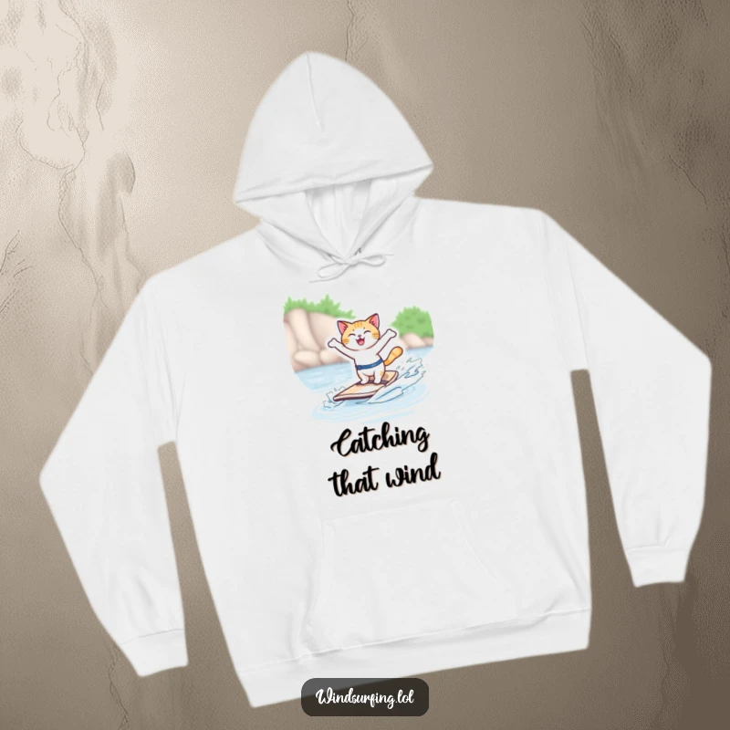 Funny hoodie with a joyful cat windsurfing, arms out, conveying freedom and fun, perfect for cozy, humorous wear.