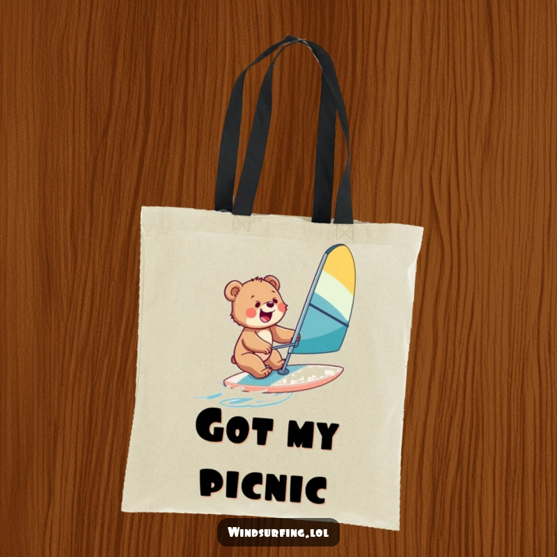 Funny tote bag with a bear cub windsurfing, ideal for carrying beach essentials and spreading cheerful vibes.