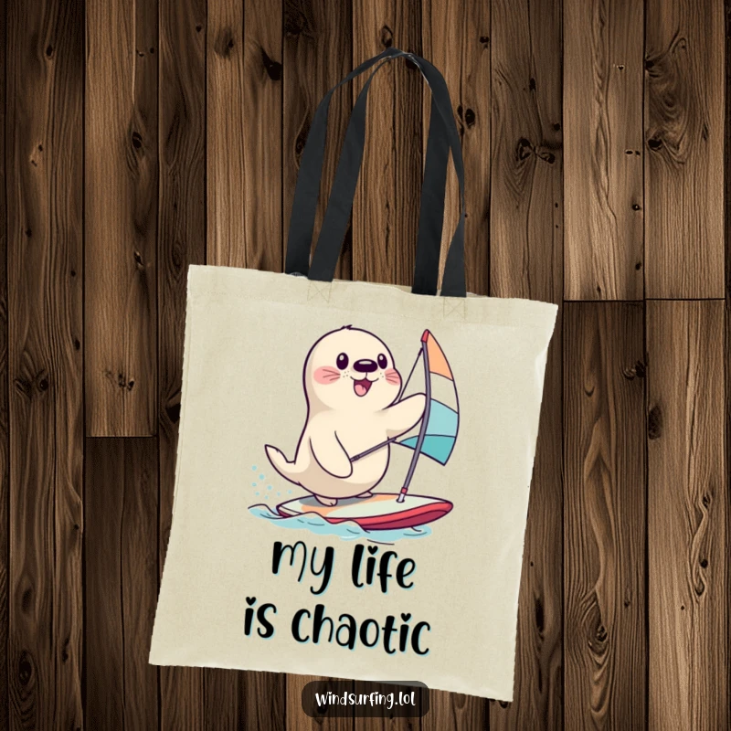 Funny seal desperately trying to stay upright on a windsurfing board, a comical scene for a funny tote bag.